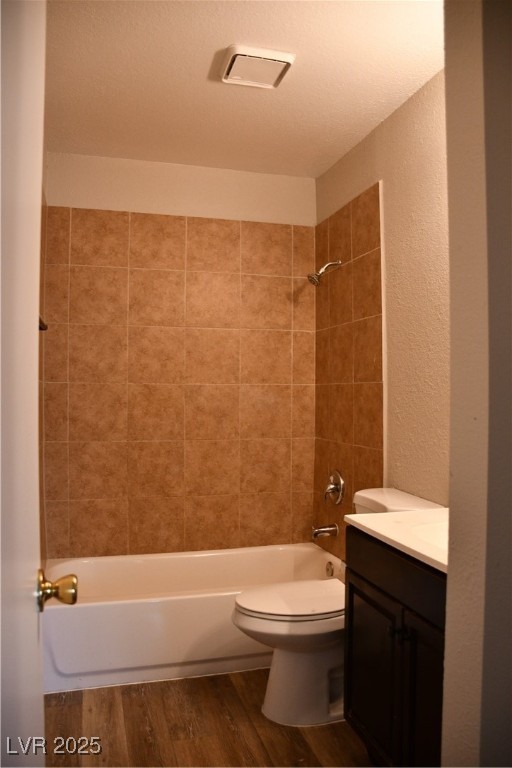 6925 Hopkins Drive, Unit 3 Las Vegas, NV 89156 - Photo 10 of 12 Bathroom with shower / washtub combination, vanity, dark wood finished floors, a textured wall, and a textured ceiling