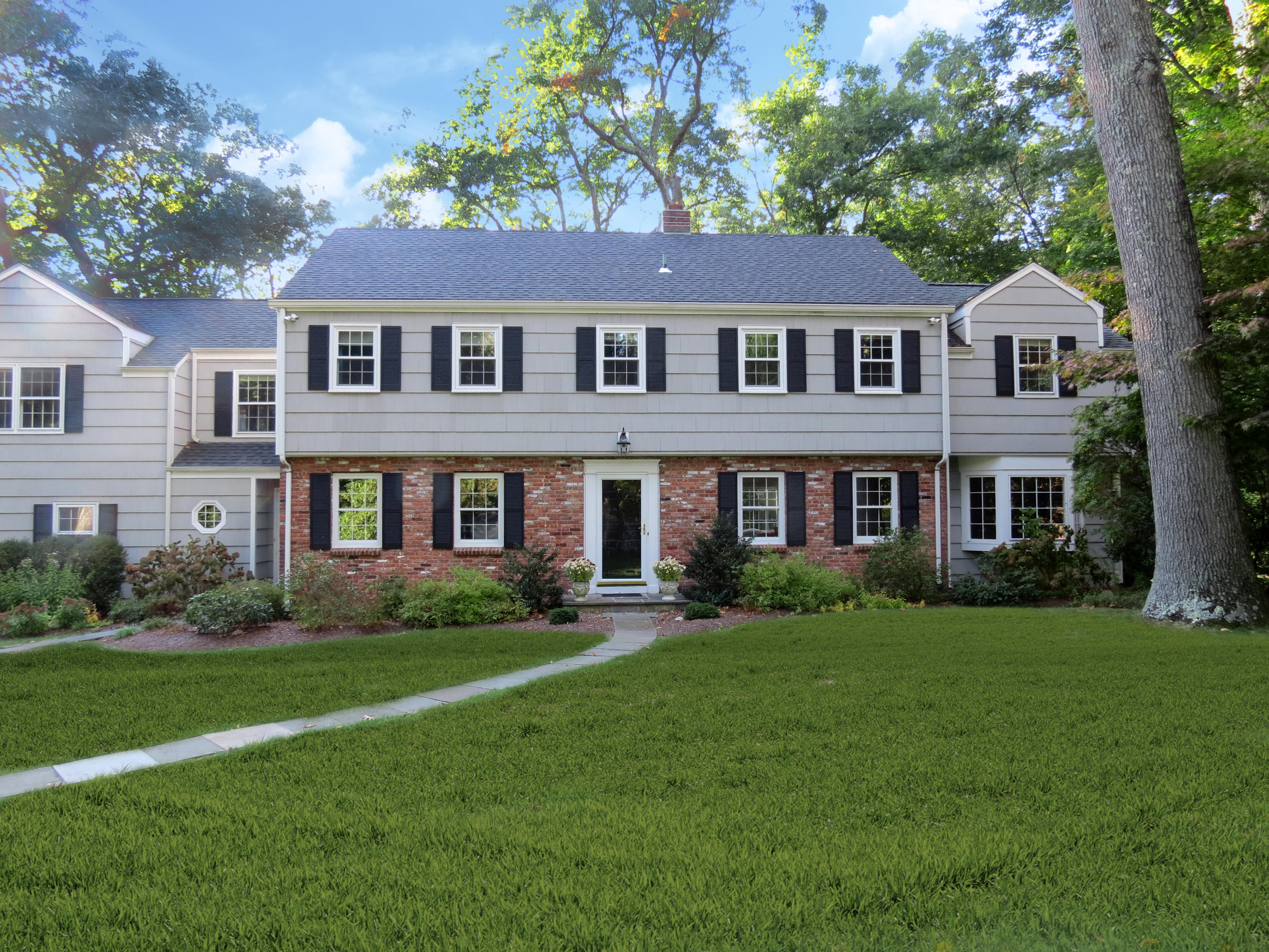 45 Silver Ridge Road New Canaan, CT 06840 - Photo 1 of 24 a front view of a house with a yard and trees