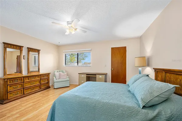 a bedroom with a large bed and a chandelier