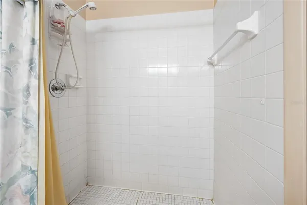 a bathroom with a glass shower door