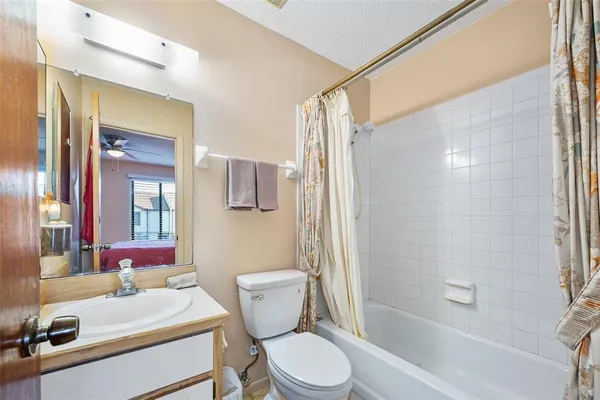 a bathroom with a sink toilet vanity and shower