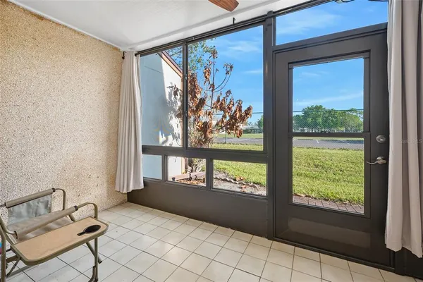 a view of front door with furniture and a window