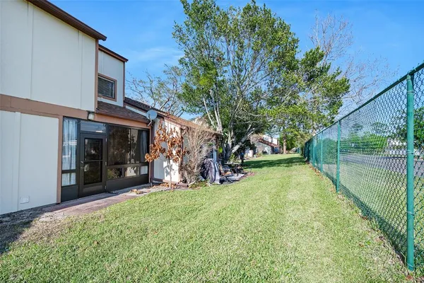 a view of a house with a yard patio and fire pit