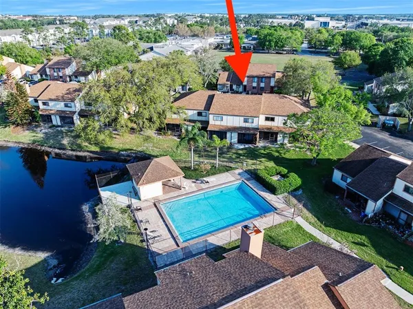 an aerial view of a house with a yard basket ball court and outdoor seating