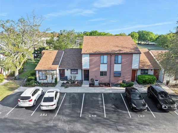 a front view of a house with a garden and plants