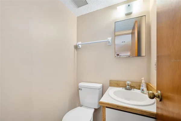 a bathroom with a sink mirror and toilet