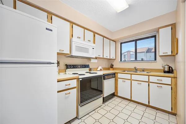 a kitchen with a stove a sink and a refrigerator