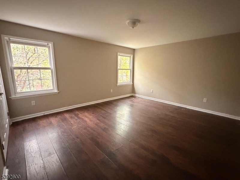 139 Inslee Place, Unit 1 Elizabeth Port, NJ 07206 - Photo 12 of 18 a view of an empty room with wooden floor and a window