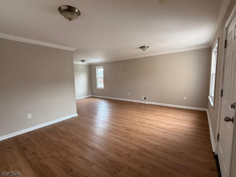 139 Inslee Place, Unit 1 Elizabeth Port, NJ 07206 - Photo 3 of 18 wooden floor in an empty room with a window