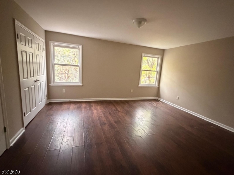 139 Inslee Place, Unit 1 Elizabeth Port, NJ 07206 - Photo 5 of 18 a view of an empty room with wooden floor and a window