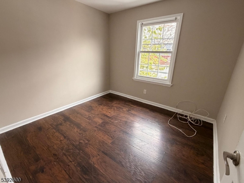 139 Inslee Place, Unit 1 Elizabeth Port, NJ 07206 - Photo 10 of 18 an empty room with wooden floor and windows