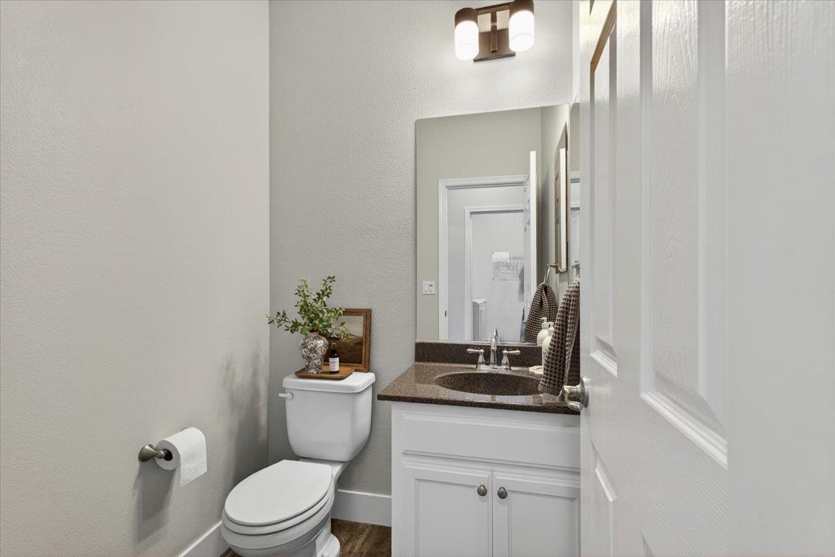437 Silver Ridge Court Oakdale, CA 95361 - Photo 27 of 41 a bathroom with a granite countertop sink a toilet and a mirror