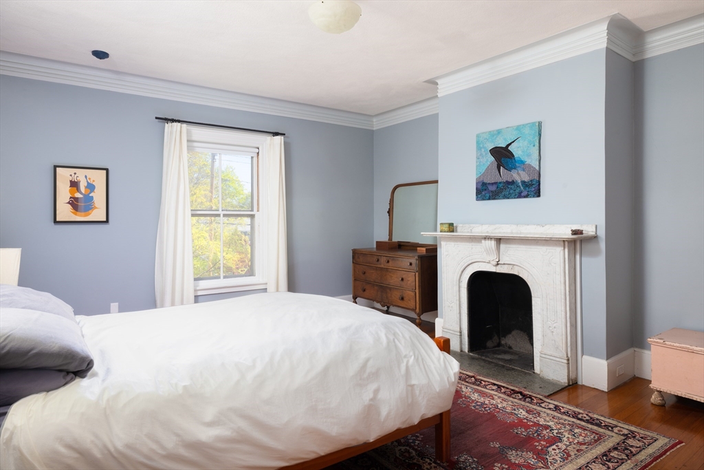135 Langley Road, Unit 135 Newton, MA 02459 - Photo 12 of 20 a bed room with a bed and a chair