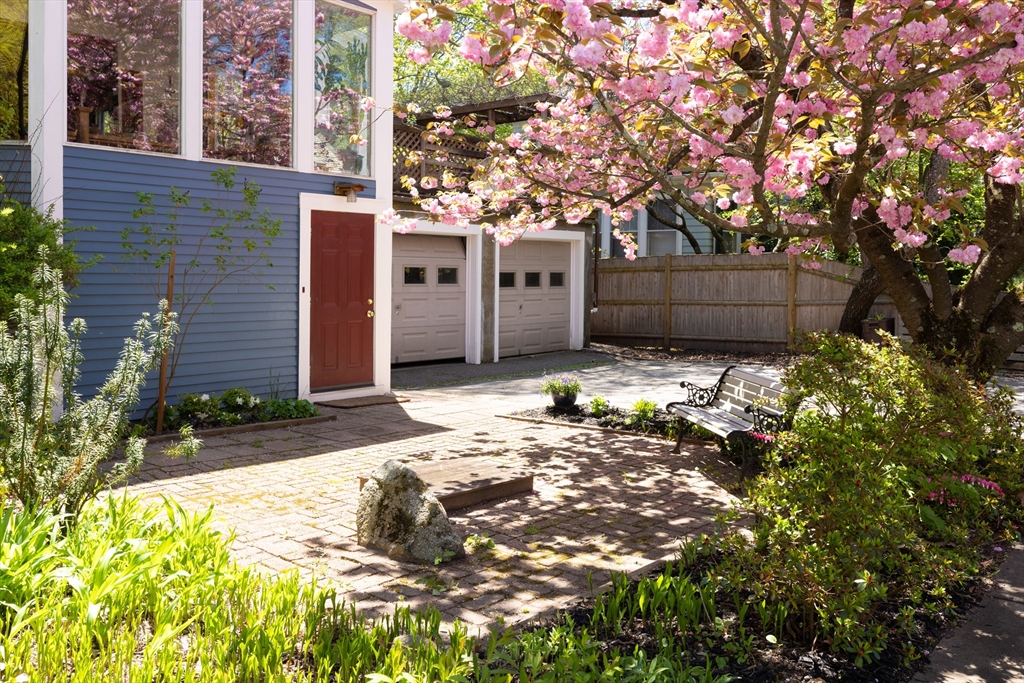 135 Langley Road, Unit 135 Newton, MA 02459 - Photo 19 of 20 a view of a house with a tree in the background