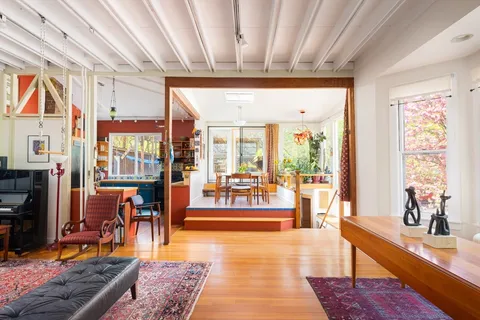 a living room with furniture a rug and a large window