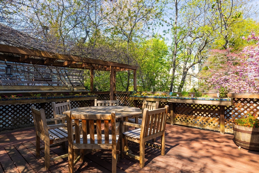135 Langley Road, Unit 135 Newton, MA 02459 - Photo 8 of 20 a view of an outdoor space with a table and chairs