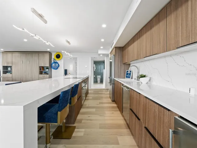 a living room with furniture and kitchen view