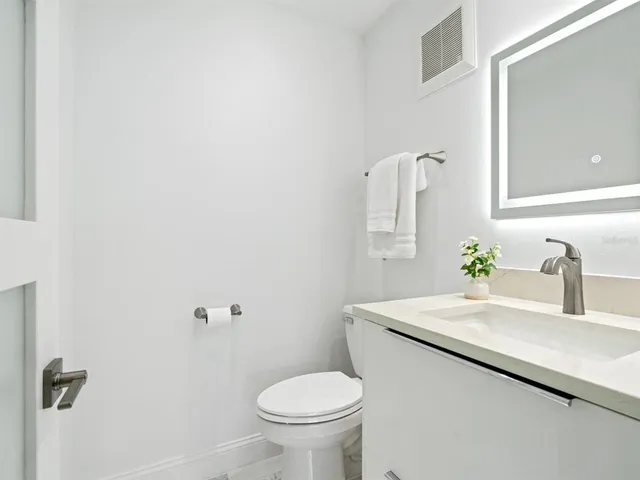 a view of a patio with lawn chairs floor to ceiling window and an outdoor view