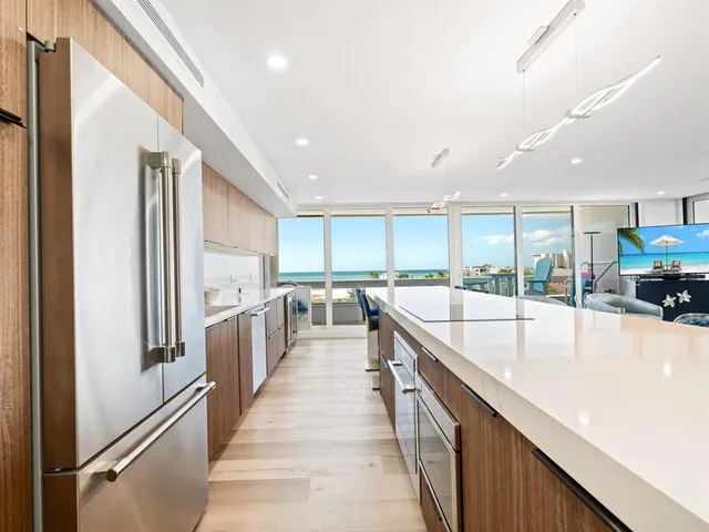 a view of a living room and floor to ceiling window or kitchen