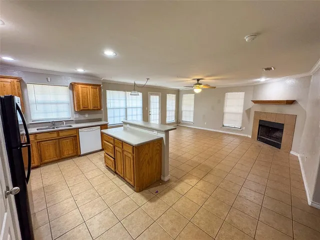 a kitchen with stainless steel appliances granite countertop a stove top oven and cabinets