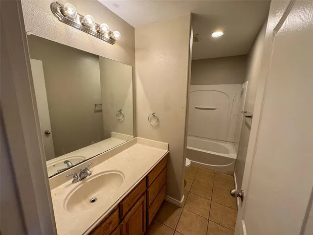 a bathroom with a sink a vanity and shower