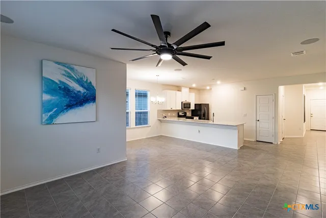 a large kitchen with a refrigerator a sink and a stove