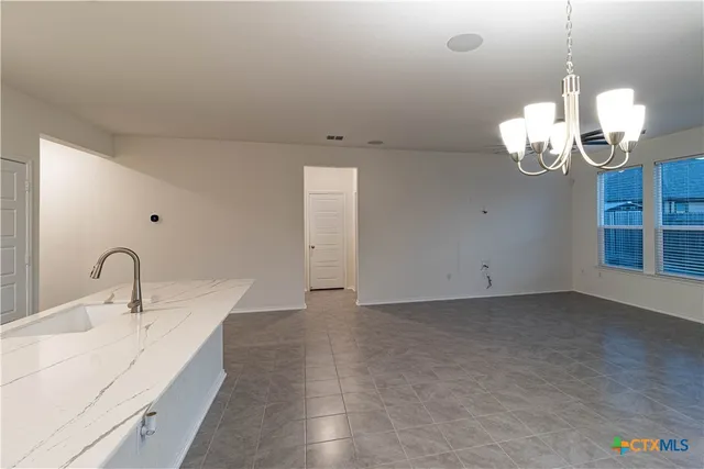 a kitchen with granite countertop a sink and a stove top oven