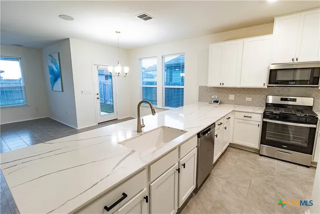 a kitchen with a refrigerator stove and microwave