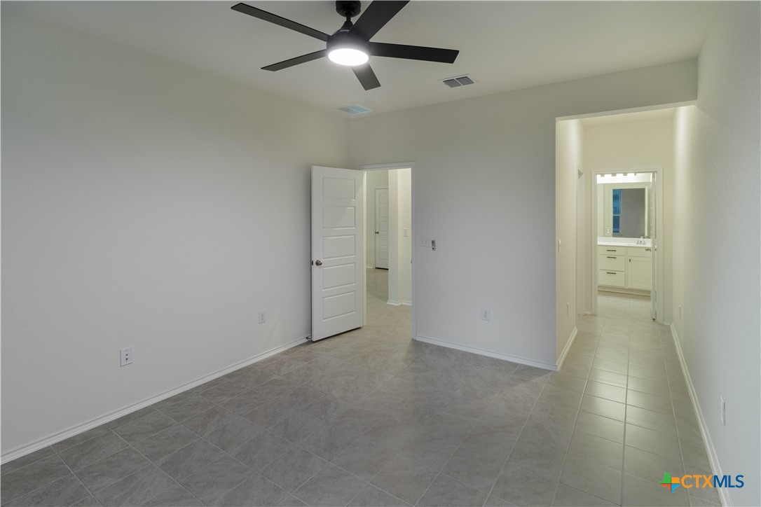 211 Summit Drive Lockhart, TX 78644 - Photo 21 of 33 an empty room with closet and a ceiling fan