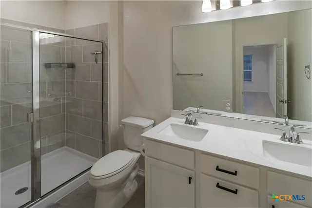 a view of yellow house with a large pool and wooden fence