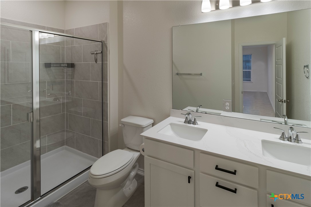 211 Summit Drive Lockhart, TX 78644 - Photo 23 of 33 a bathroom with a sink toilet and shower