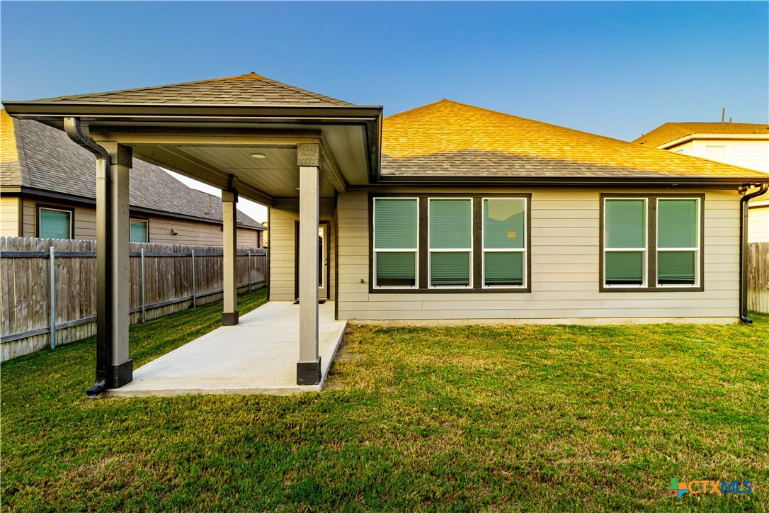211 Summit Drive Lockhart, TX 78644 - Photo 24 of 33 a view of yellow house with a large pool and wooden fence