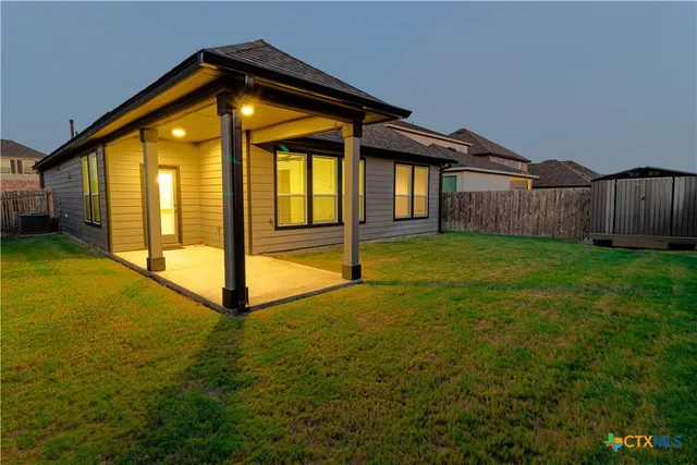 a view of a house with backyard and porch