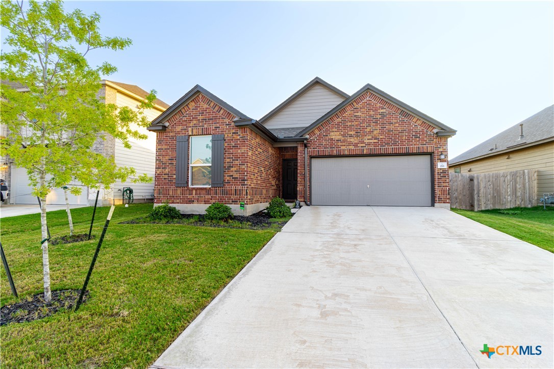 211 Summit Drive Lockhart, TX 78644 - Photo 6 of 33 a front view of a house with garden