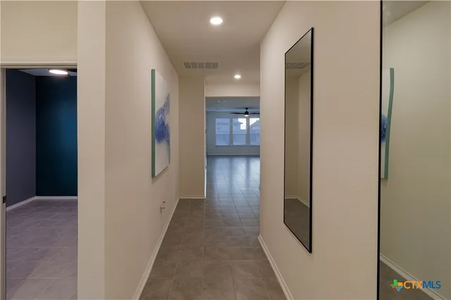 a view of an empty room with closet and a window