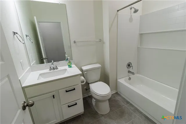 a view of an empty room with closet and window