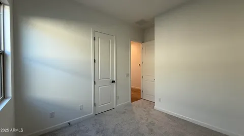 an empty room with closet area