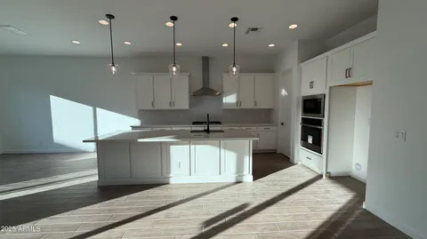 a large kitchen with kitchen island a sink stainless steel appliances and cabinets