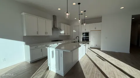 a kitchen with a stove a sink and a refrigerator