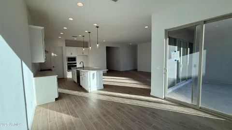 a view of kitchen with furniture and refrigerator