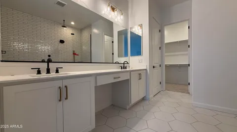a bathroom with a double vanity sink mirror and