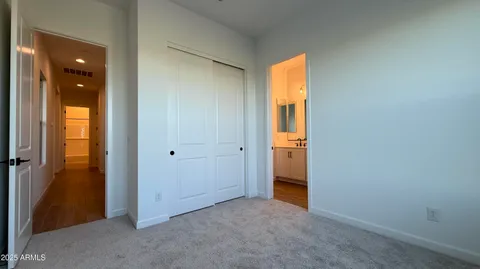 an empty room with windows and bathroom view