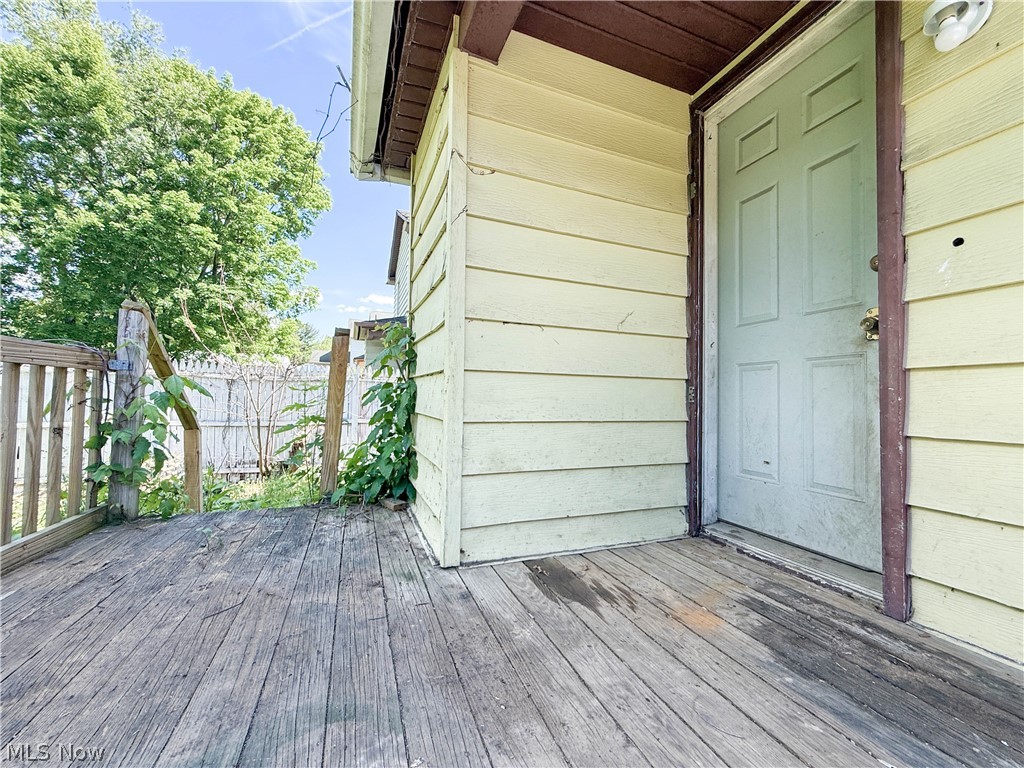 3443 Sheridan Road Youngstown, OH 44502 - Photo 20 of 24 Wooden deck entrance with horizontal siding and a paneled door