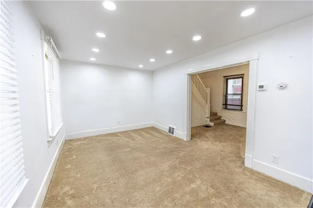 a view of an empty room and wooden floor