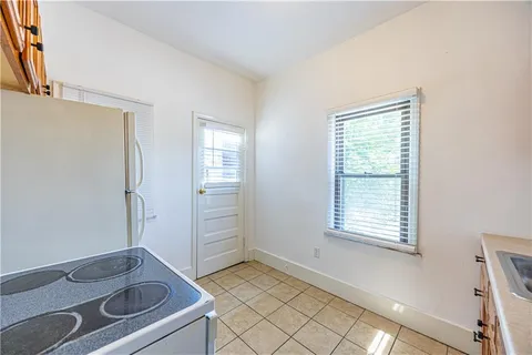 a kitchen with stainless steel appliances a stove a refrigerator and cabinets
