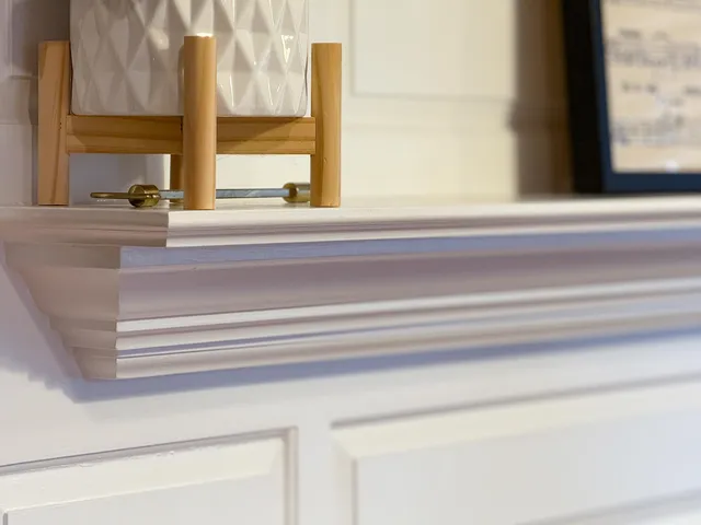 a view of a livingroom with wooden floor and a fireplace