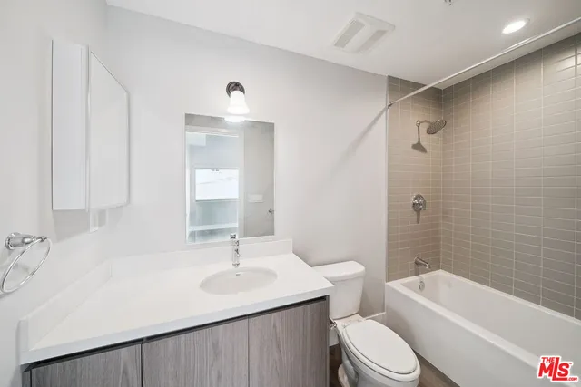 a bathroom with a sink toilet tub and shower