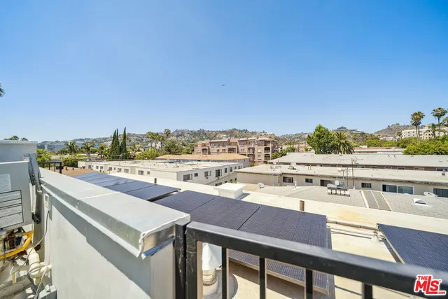 a view of a balcony with furniture and city view