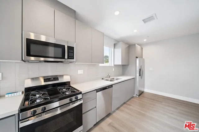 a kitchen with a sink stove and microwave