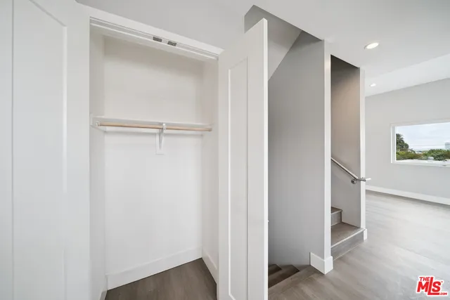 a view of hallway with wooden floor